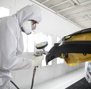 Collision Center Technician Painting a Vehicle | Findlay Toyota Flagstaff in Flagstaff AZ